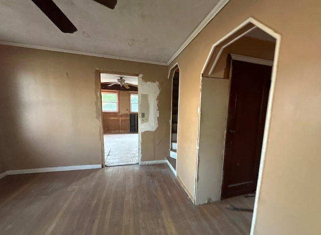 interior space featuring ornamental molding and dark wood-type flooring