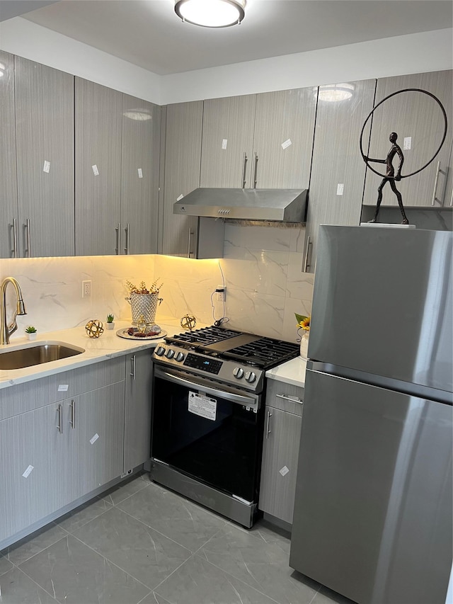 kitchen with tasteful backsplash, gray cabinetry, sink, and stainless steel appliances