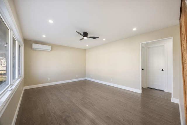 unfurnished room featuring ceiling fan, dark hardwood / wood-style flooring, and a wall mounted air conditioner