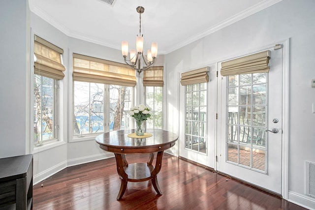 interior space featuring crown molding, dark wood-type flooring, and an inviting chandelier