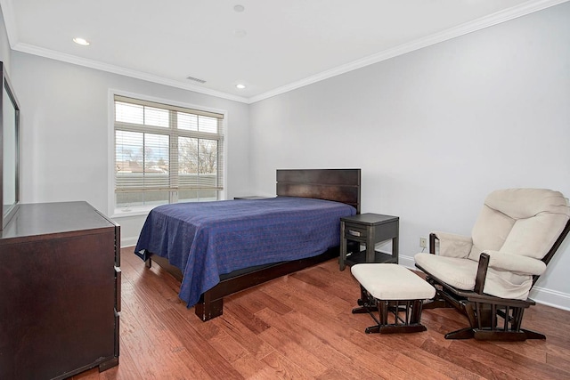 bedroom with hardwood / wood-style floors and crown molding