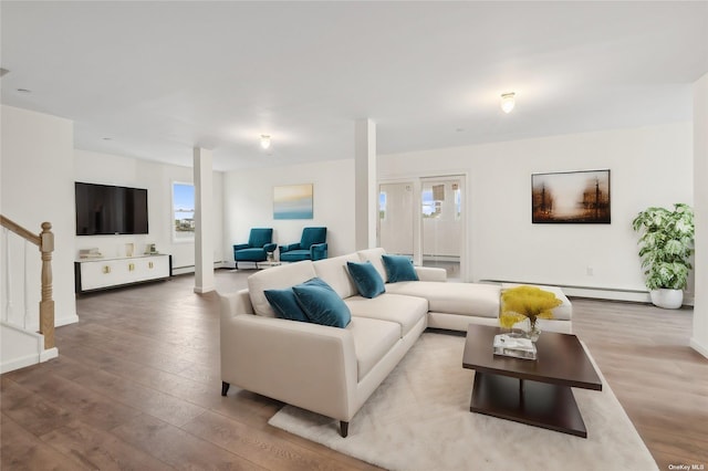 living room with baseboard heating and light wood-type flooring