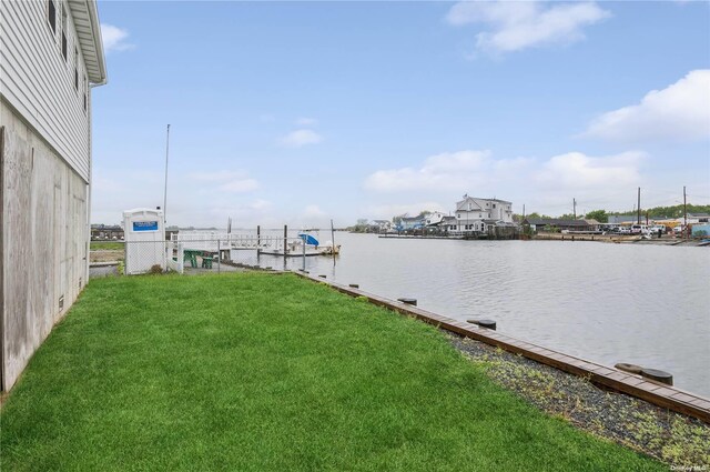 dock area featuring a yard and a water view