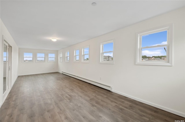 spare room with hardwood / wood-style floors and a baseboard radiator