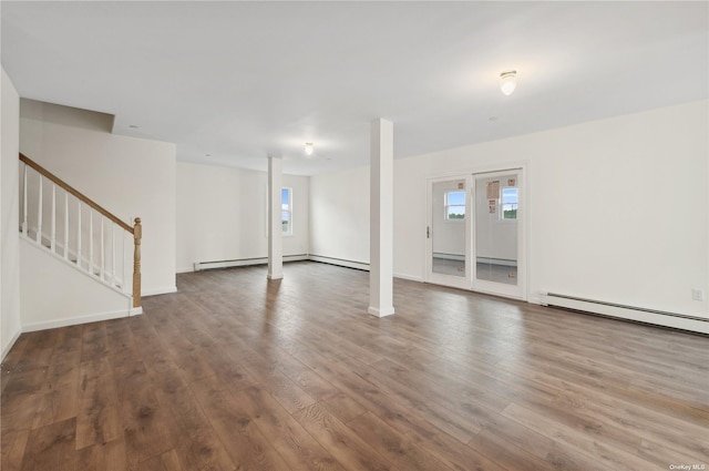 interior space featuring hardwood / wood-style flooring, a wealth of natural light, and a baseboard heating unit