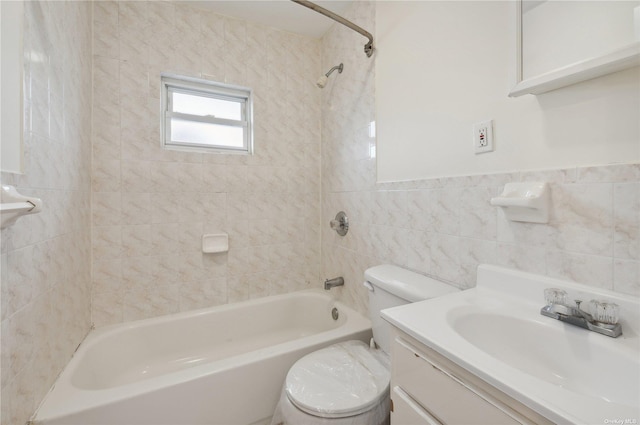 full bathroom featuring vanity, toilet, tile walls, and tiled shower / bath