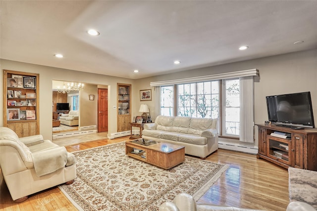 living room with a baseboard heating unit, an inviting chandelier, recessed lighting, and light wood-type flooring