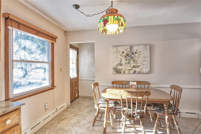 dining room with light tile patterned floors, baseboards, and a baseboard radiator