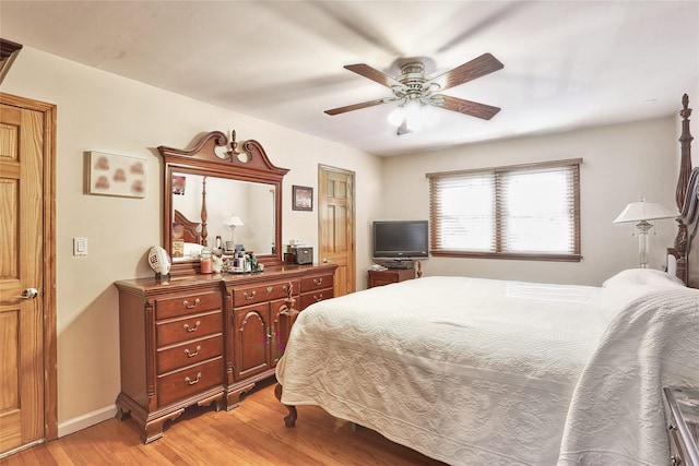 bedroom with ceiling fan, baseboards, and light wood-style flooring