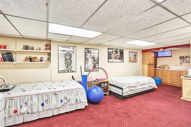 bedroom featuring a paneled ceiling and dark colored carpet