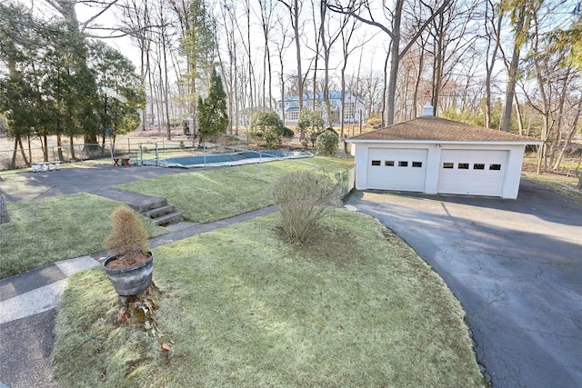 exterior space featuring an outdoor structure, fence, and a garage