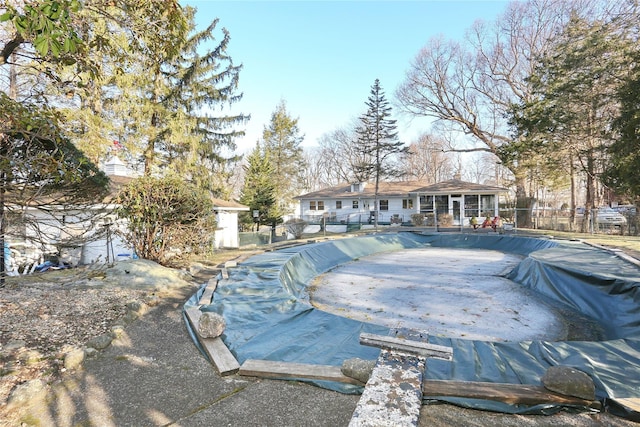 exterior space with a fenced in pool, a patio area, an outdoor structure, and fence