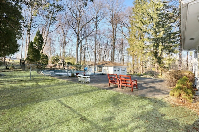 view of yard with an outdoor structure and fence