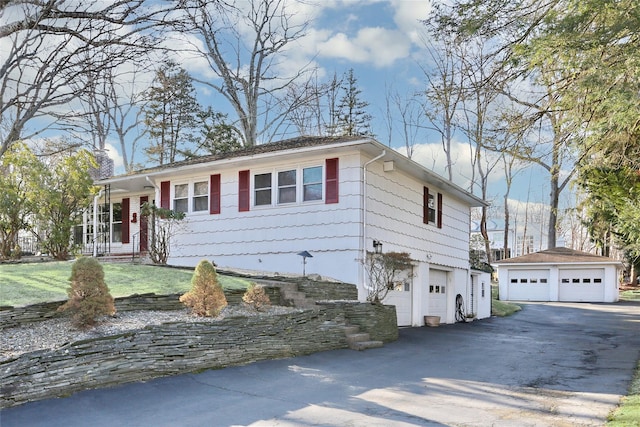 single story home with an outbuilding and an attached garage