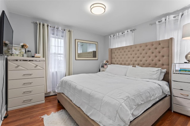 bedroom with dark hardwood / wood-style floors