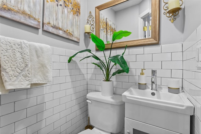 bathroom featuring toilet, tile walls, and tasteful backsplash