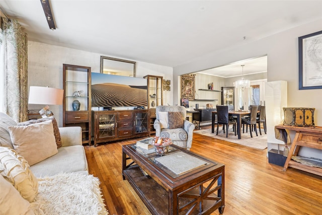 living room with a chandelier and wood-type flooring