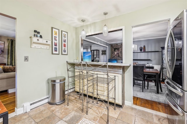 kitchen with stainless steel fridge, pendant lighting, and a baseboard radiator