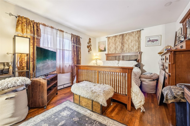 bedroom featuring baseboard heating and dark wood-type flooring