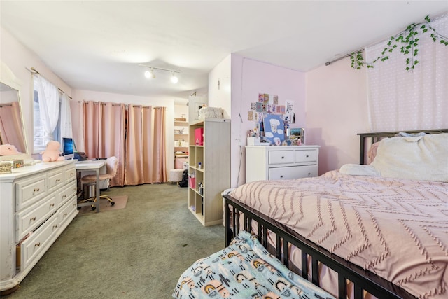 carpeted bedroom with built in desk