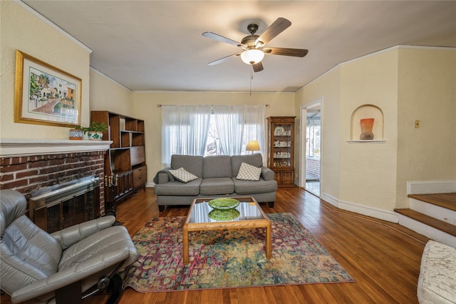 living room featuring a fireplace, ceiling fan, and dark wood-type flooring