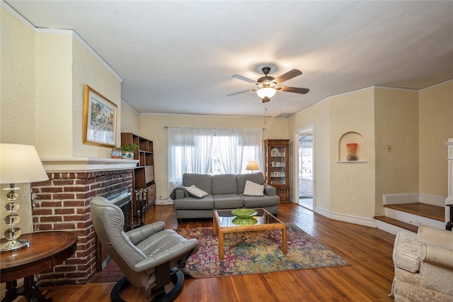 living room featuring a fireplace, hardwood / wood-style floors, and ceiling fan