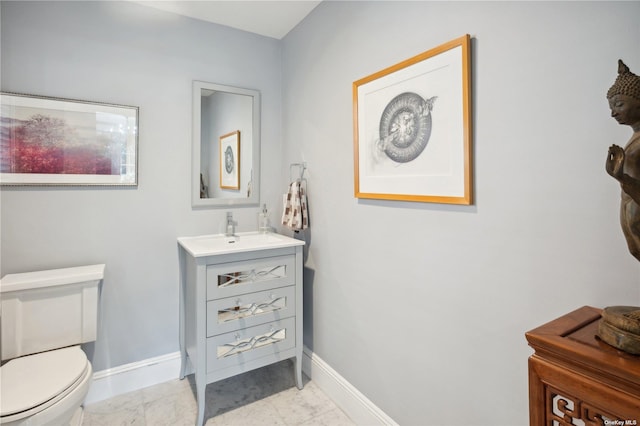 bathroom featuring tile patterned floors, vanity, and toilet