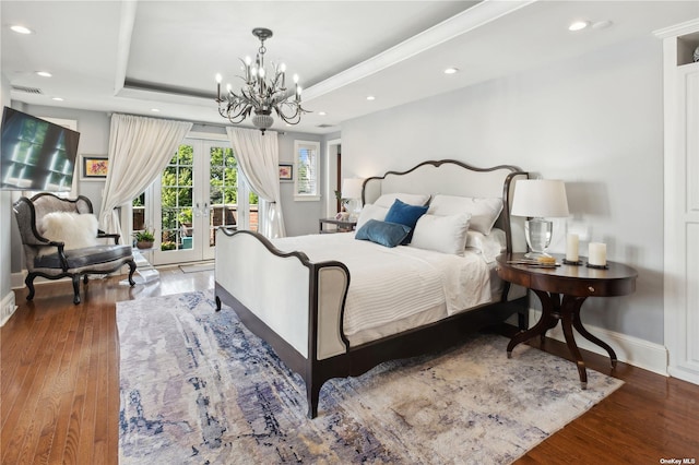 bedroom featuring french doors, access to outside, a raised ceiling, wood-type flooring, and a chandelier