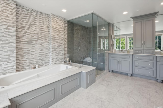 bathroom featuring vanity and independent shower and bath