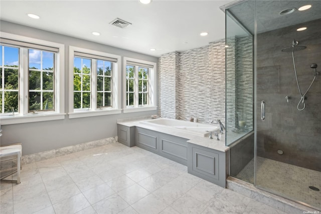 bathroom with shower with separate bathtub