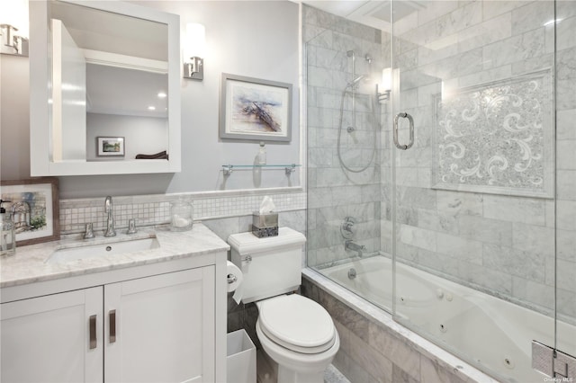 full bathroom with vanity, toilet, and bath / shower combo with glass door