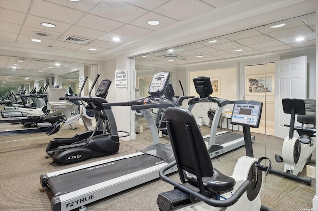 exercise room featuring a drop ceiling and crown molding