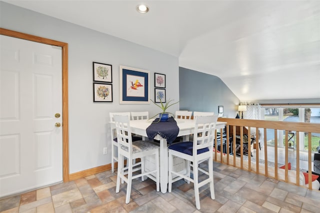 dining space featuring vaulted ceiling