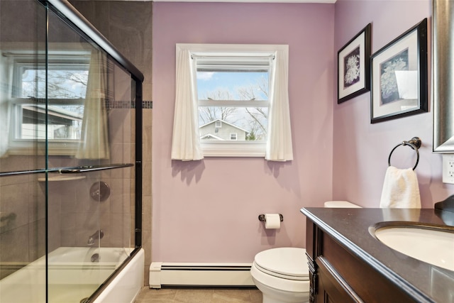 full bathroom featuring tile patterned floors, vanity, shower / bath combination with glass door, a baseboard radiator, and toilet