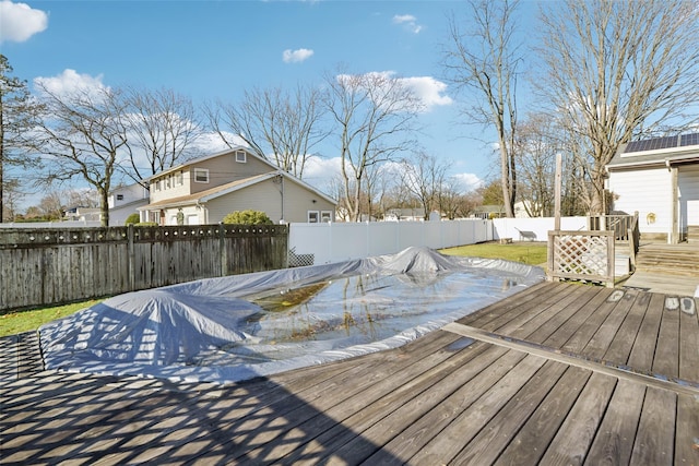 deck featuring a covered pool