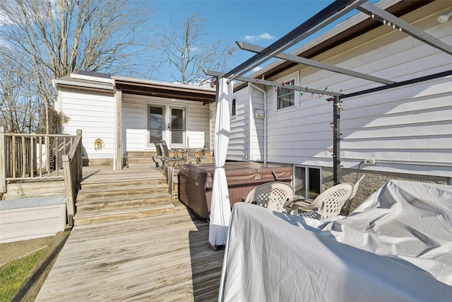 wooden deck featuring a hot tub