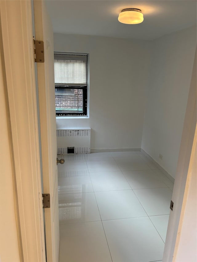 tiled spare room with radiator