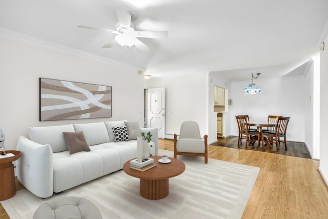 living room with hardwood / wood-style flooring, crown molding, and ceiling fan