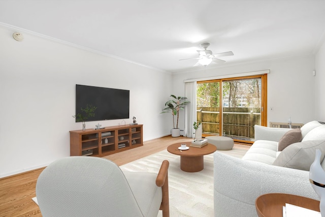 living room featuring hardwood / wood-style flooring, ceiling fan, and ornamental molding