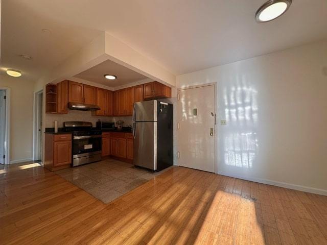 kitchen featuring appliances with stainless steel finishes and hardwood / wood-style flooring