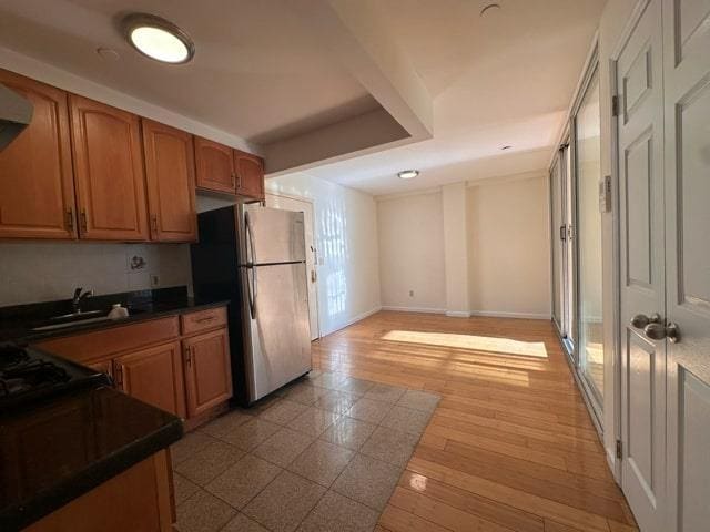 kitchen with sink and stainless steel refrigerator