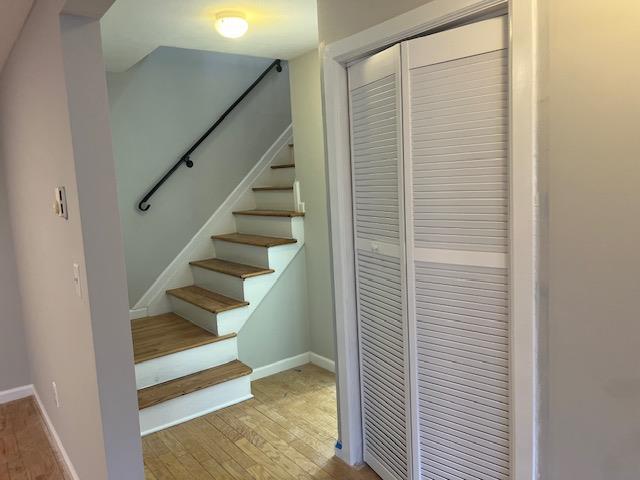 staircase with hardwood / wood-style floors