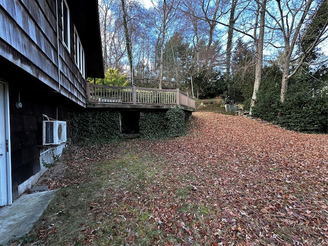 view of yard with ac unit and a deck