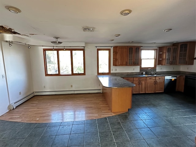 kitchen featuring sink, baseboard heating, dark tile patterned floors, stainless steel dishwasher, and a kitchen island