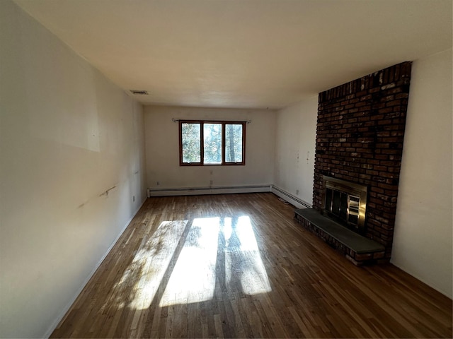 unfurnished living room with a fireplace and hardwood / wood-style flooring