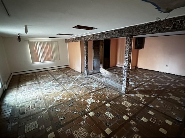 empty room featuring a baseboard heating unit