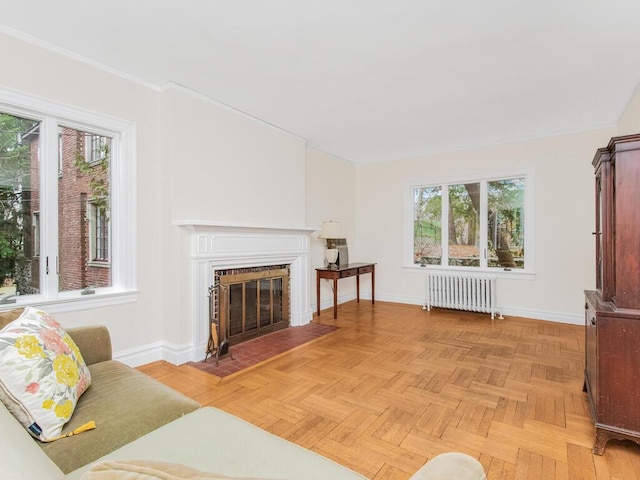 living room with radiator, plenty of natural light, and light parquet floors