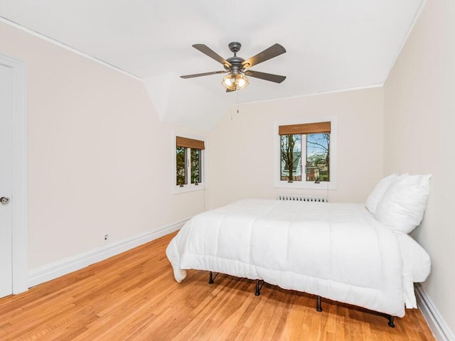 bedroom with multiple windows, hardwood / wood-style flooring, and ceiling fan