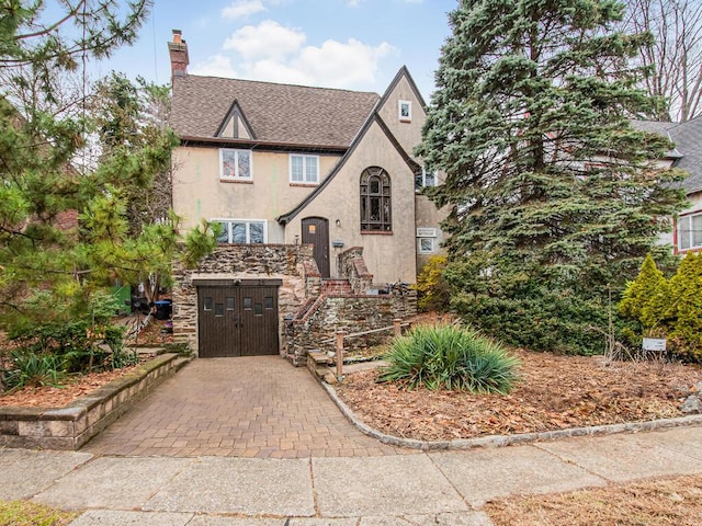 tudor-style house with a garage