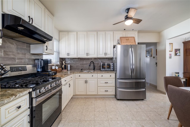 kitchen with decorative backsplash, ceiling fan, light stone counters, and appliances with stainless steel finishes